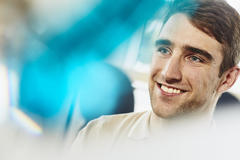 Close up - smiling man looking away.
