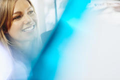 Close up - smiling woman looking away.