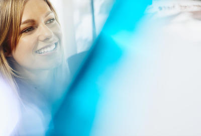Close up - smiling woman looking away.